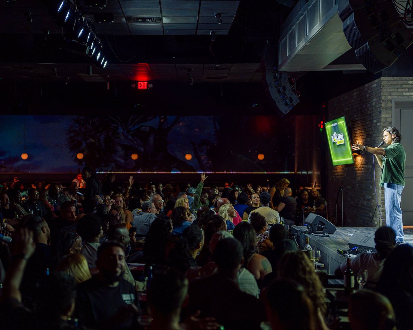 Lando working a packed, sold-out club room