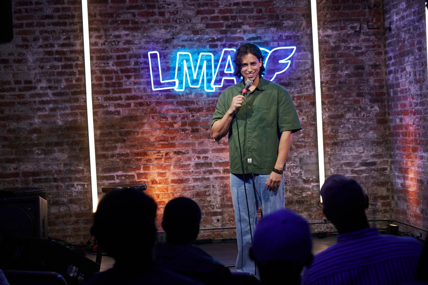 Lando on stage in front of the LMAOF neon sign