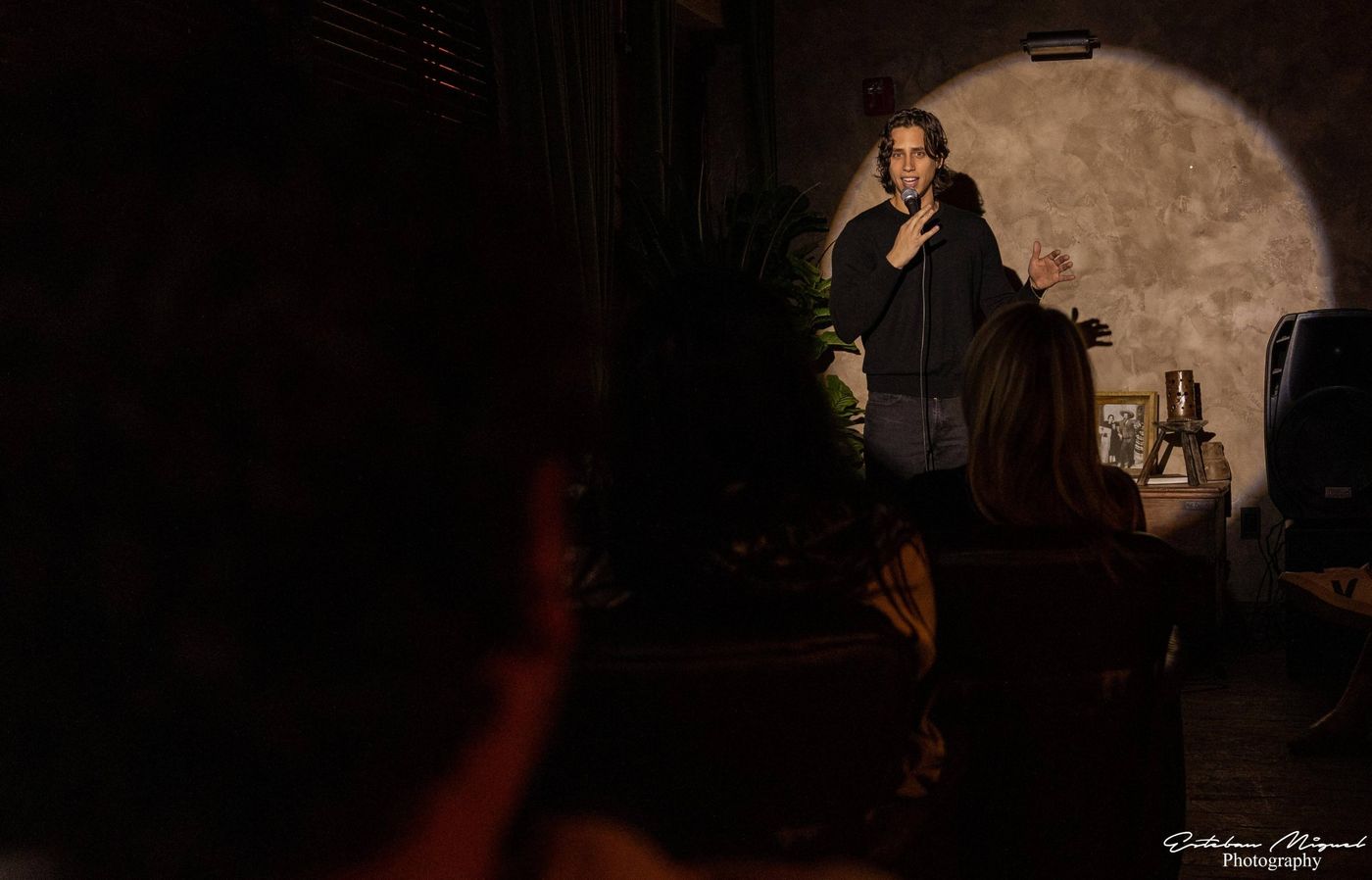 Lando on stage in a spotlight at an intimate venue